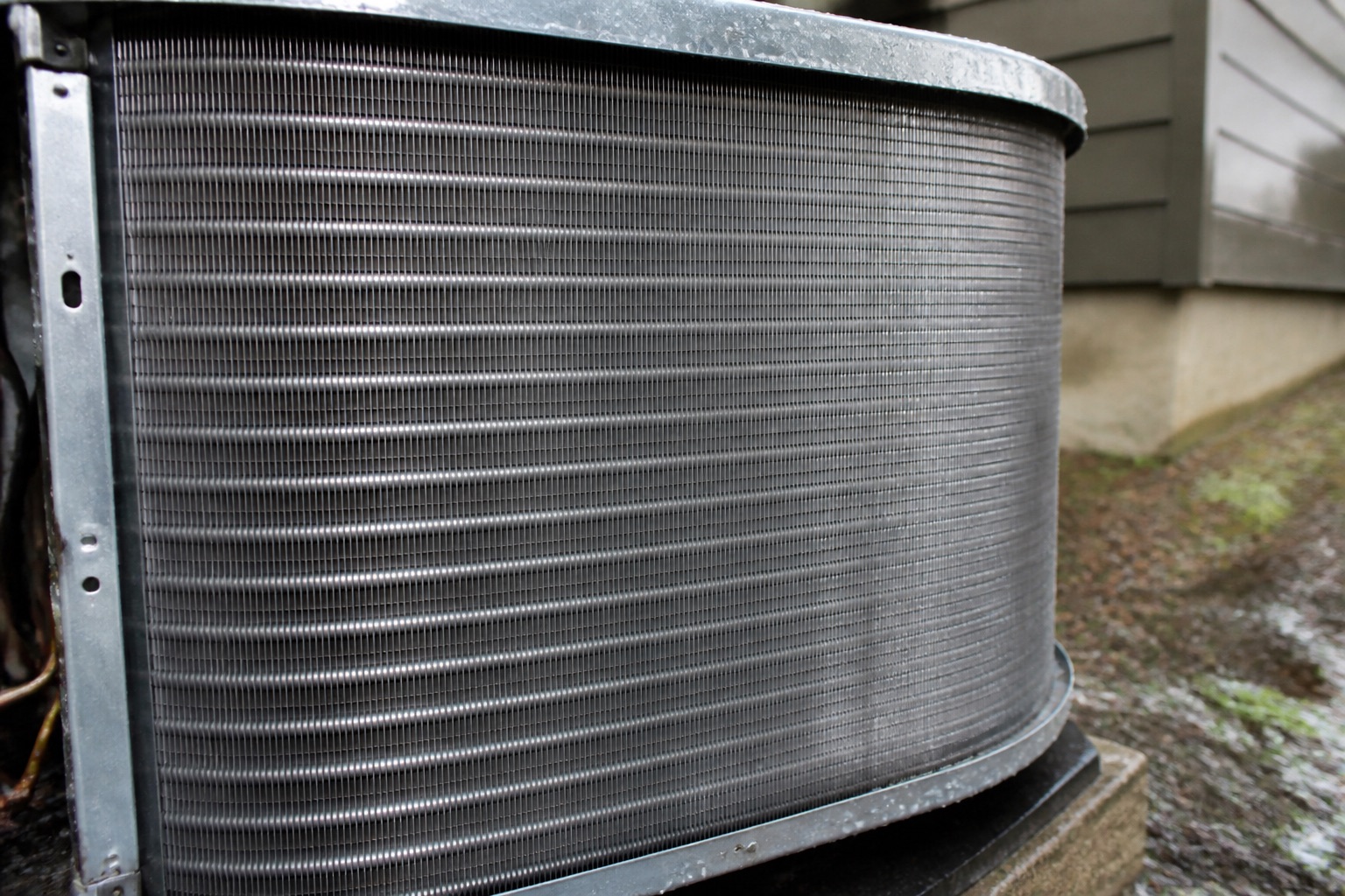 Clean residential condenser coil prepared for an AC maintenance inspection